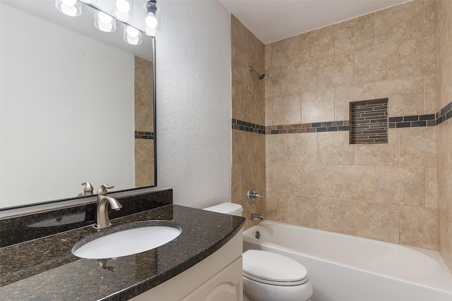 full bathroom with toilet, vanity, and tiled shower / bath