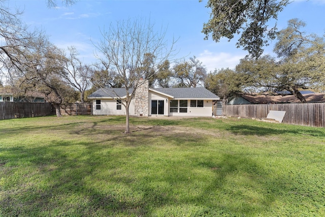 rear view of house with a lawn