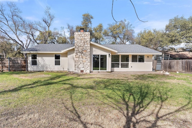 rear view of property featuring a patio area and a lawn