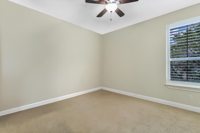 carpeted spare room featuring ceiling fan