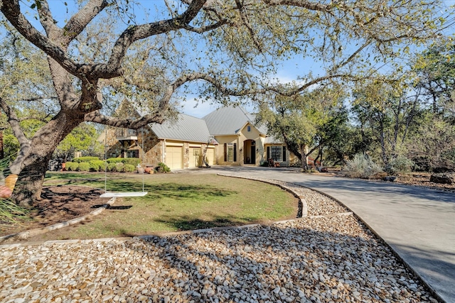 view of front of house with a front yard and a garage