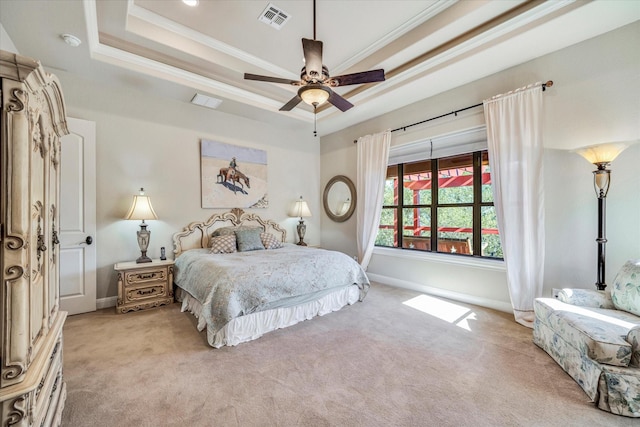 carpeted bedroom with ceiling fan, ornamental molding, and a raised ceiling