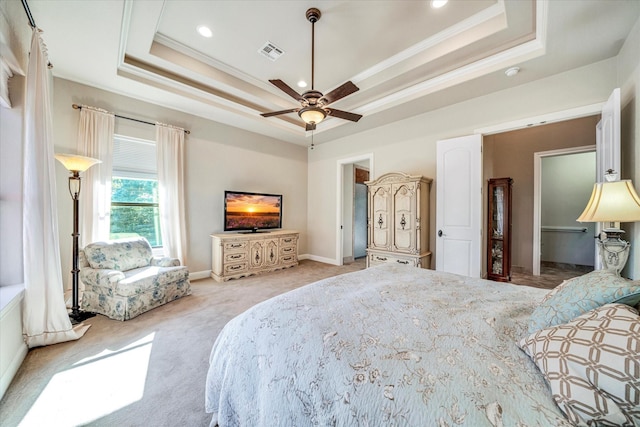 carpeted bedroom featuring ceiling fan, crown molding, and a raised ceiling