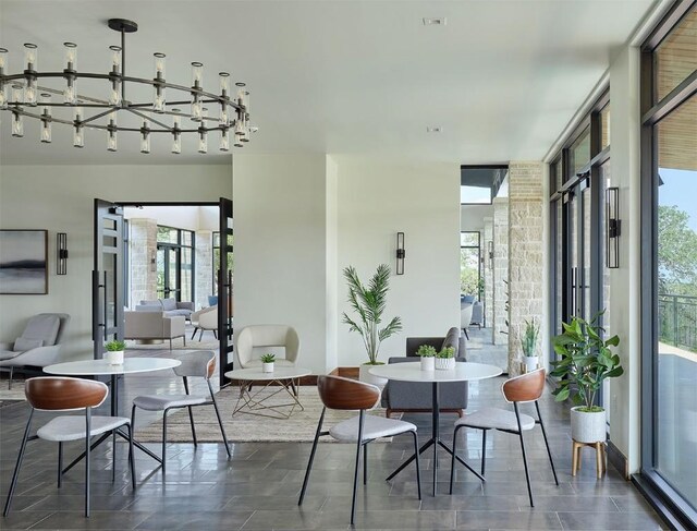 dining room featuring a wall of windows and a healthy amount of sunlight