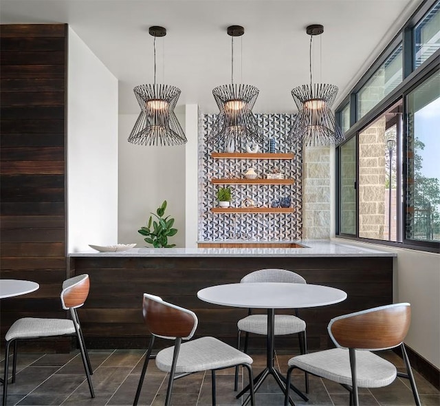 bar featuring tile patterned flooring, a dry bar, and decorative light fixtures