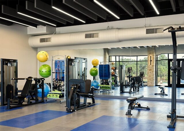 exercise room featuring a high ceiling and visible vents