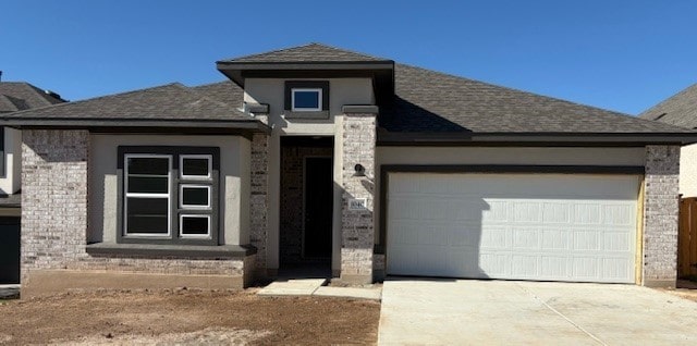 prairie-style house featuring a garage