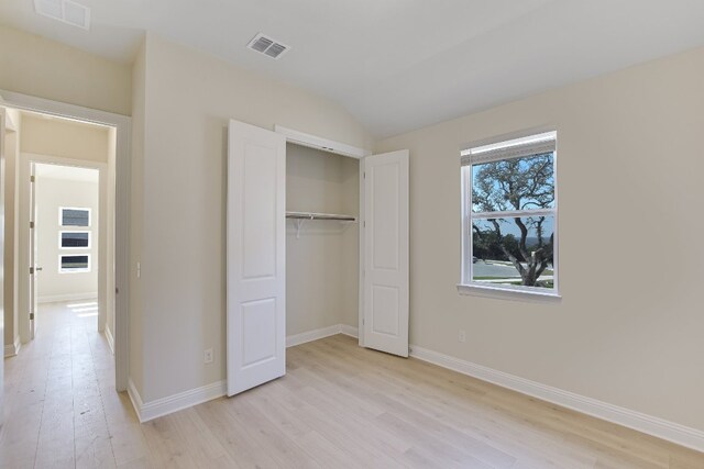 unfurnished bedroom with light wood-style floors, visible vents, and baseboards