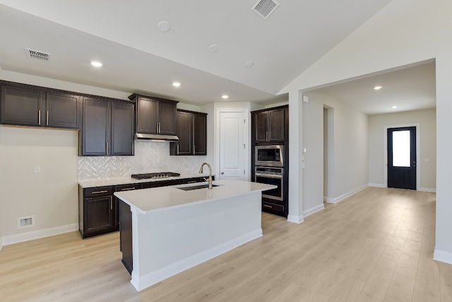 kitchen featuring a sink, stainless steel appliances, visible vents, and under cabinet range hood