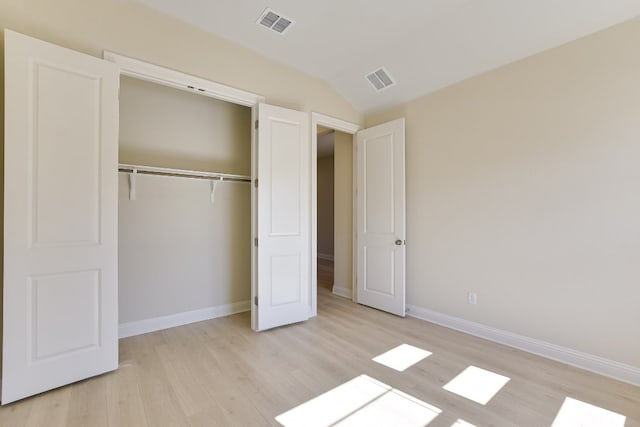 unfurnished bedroom with a closet, visible vents, baseboards, and light wood-style floors