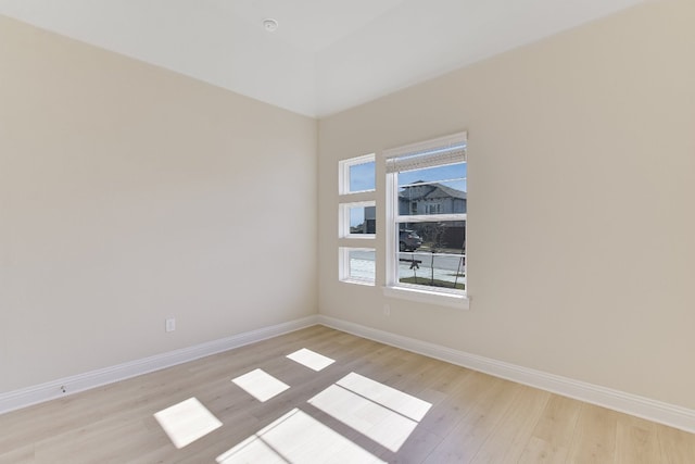 unfurnished room with light wood-style floors and baseboards