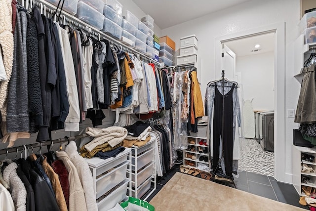 walk in closet featuring dark tile patterned floors