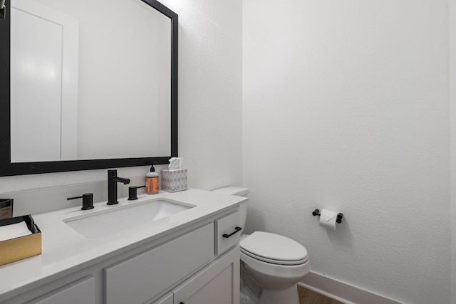 bathroom with toilet and vanity