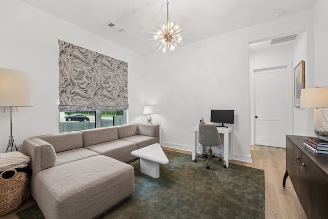 living room with an inviting chandelier and hardwood / wood-style flooring