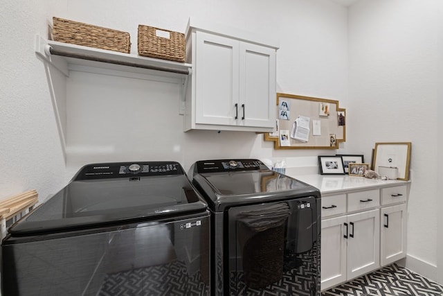 laundry area featuring cabinets and washer and clothes dryer