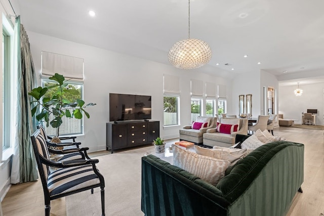 living room featuring light hardwood / wood-style floors and a notable chandelier