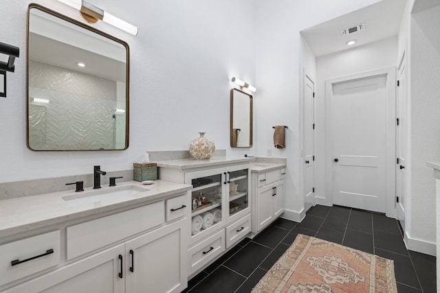 bathroom featuring vanity, tile patterned flooring, and a shower