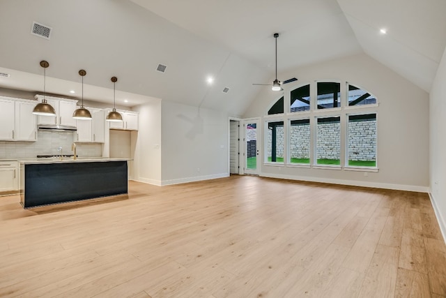 8412 Bouvreuil Dr, Austin, TX 78738 - unfurnished living room with a ceiling fan, high vaulted ceiling, light wood-style flooring, and recessed lighting
