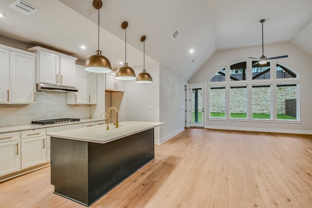 8412 Bouvreuil Dr, Austin, TX 78738 - kitchen featuring light countertops, backsplash, white cabinetry, pendant lighting, and recessed lighting
