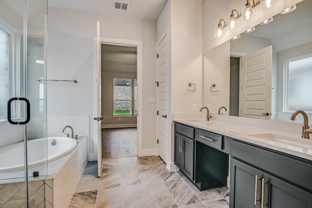 8412 Bouvreuil Dr, Austin, TX 78738 - full bath with double vanity, tiled bath, and marble look tiles