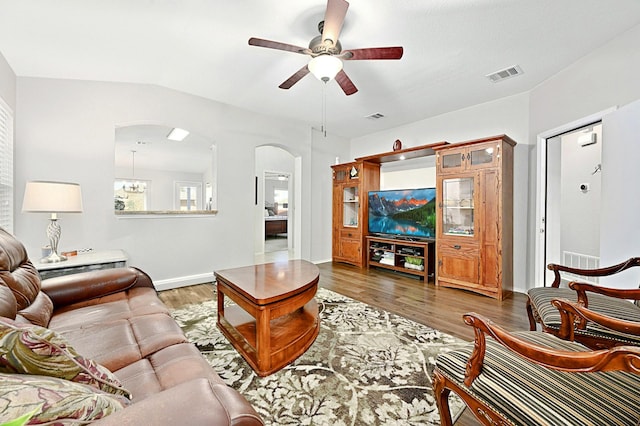 living room with ceiling fan and dark hardwood / wood-style flooring