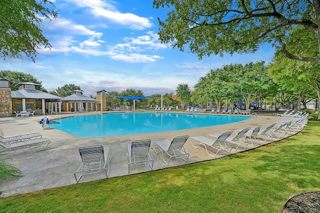 view of swimming pool with a gazebo and a lawn