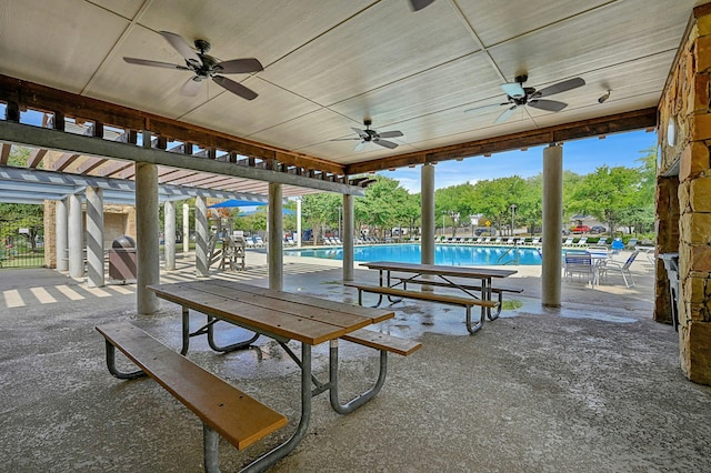 view of patio featuring ceiling fan and a community pool