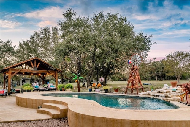 view of swimming pool featuring pool water feature, a gazebo, and a patio