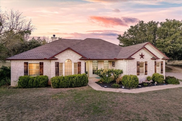 ranch-style house with a yard