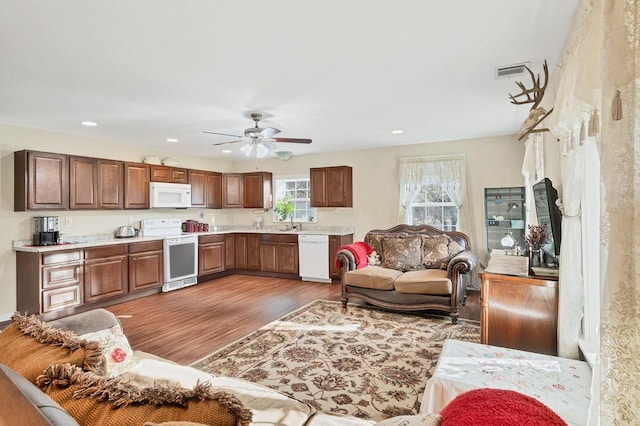 living room with hardwood / wood-style flooring and ceiling fan