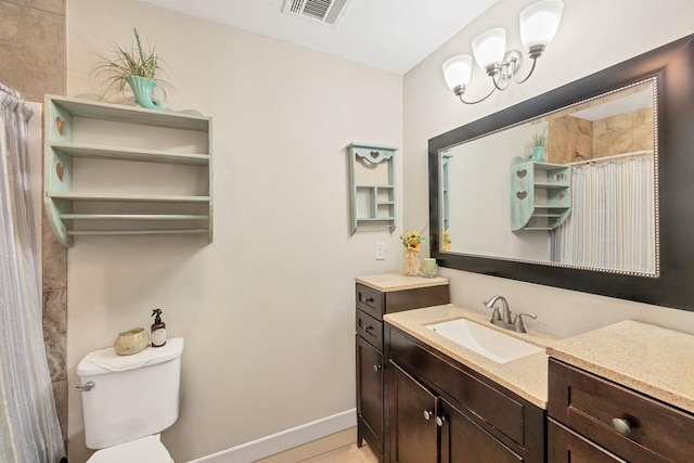 bathroom with toilet and vanity