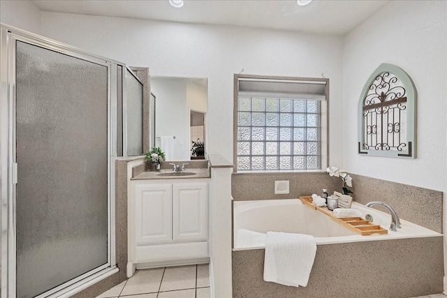 bathroom featuring tile patterned floors, vanity, and plus walk in shower