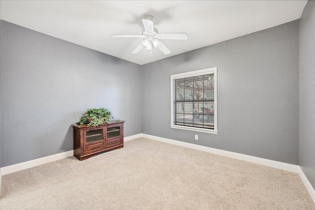 carpeted empty room with ceiling fan