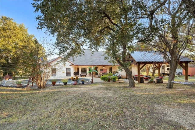 back of house featuring a gazebo and a yard