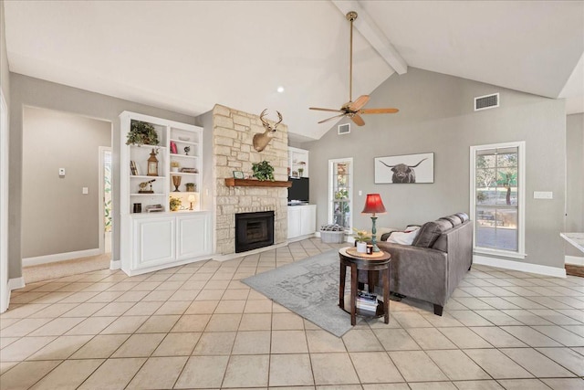 living room featuring ceiling fan, light tile patterned floors, lofted ceiling with beams, and a fireplace