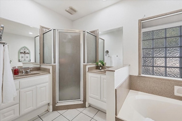 bathroom featuring shower with separate bathtub, vanity, a healthy amount of sunlight, and tile patterned flooring