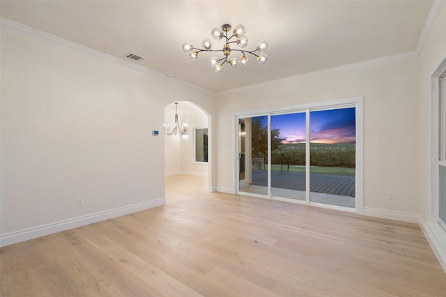 unfurnished room featuring a notable chandelier, ornamental molding, and light hardwood / wood-style floors