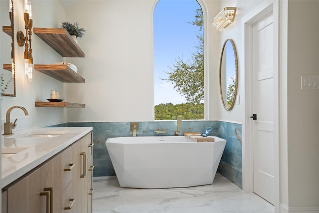 bathroom featuring vanity and a tub