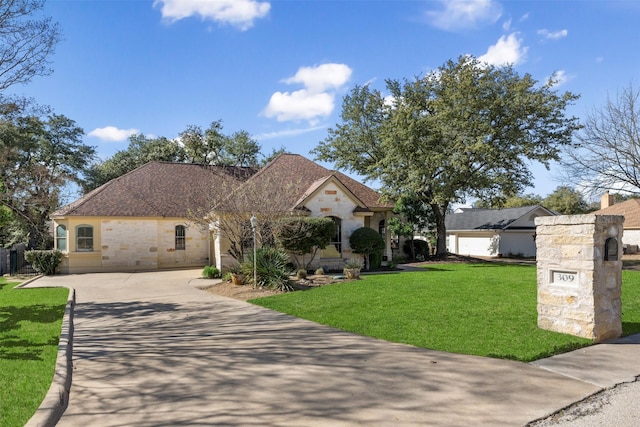 view of front of property with a garage and a front lawn