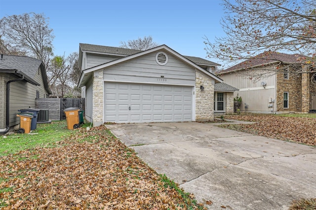 view of front of property with a garage and central air condition unit