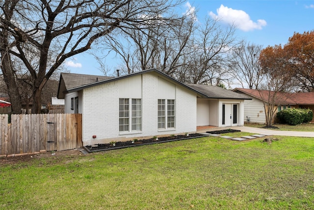 view of front of house with a front yard and french doors