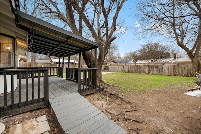 wooden deck featuring a lawn