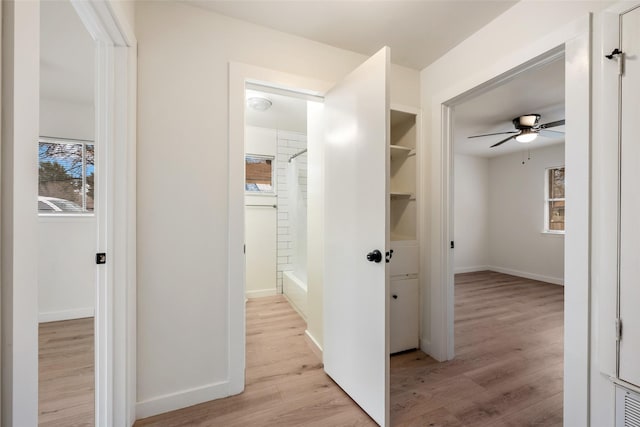 corridor with light hardwood / wood-style floors