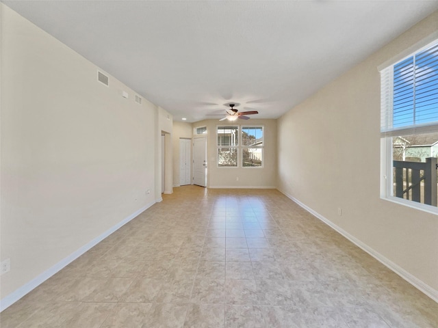 tiled spare room featuring ceiling fan