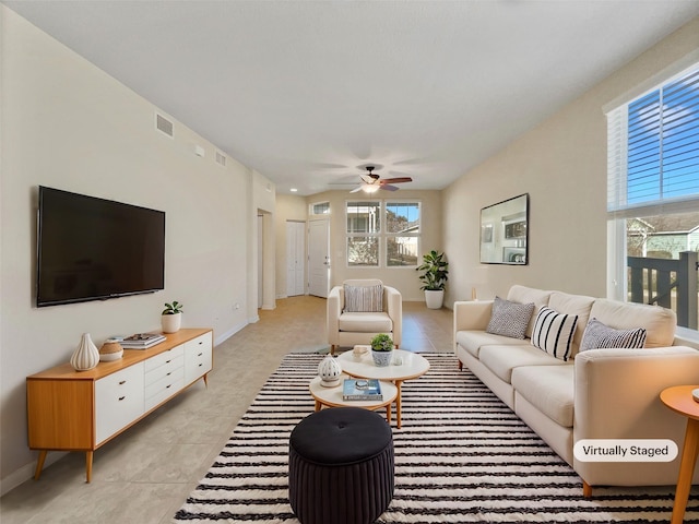 tiled living room featuring ceiling fan