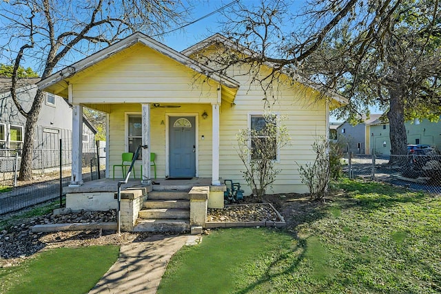 bungalow-style home featuring a porch and a front yard