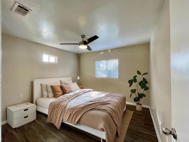 bedroom with ceiling fan and dark hardwood / wood-style floors