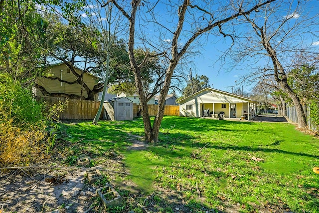 view of yard with a storage shed and a patio area