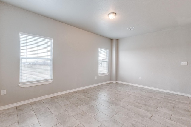 spare room with light tile patterned flooring