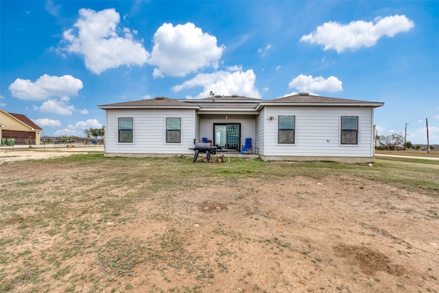 back of house with a lawn